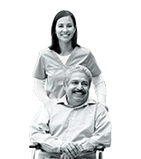 Man in wheelchair while nurse pushes them